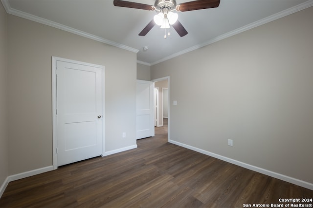 unfurnished bedroom with ceiling fan, dark wood-type flooring, and crown molding