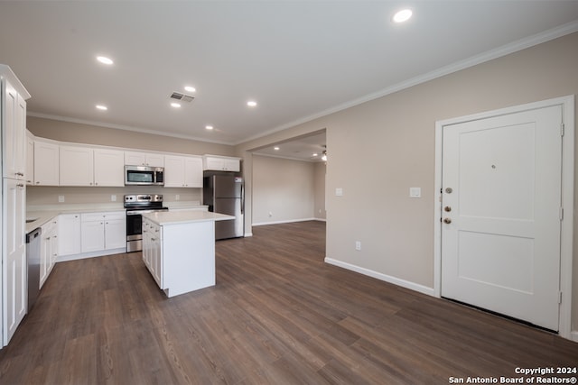 kitchen with white cabinetry, dark wood-type flooring, appliances with stainless steel finishes, and a kitchen island