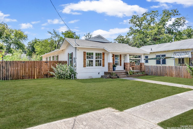 bungalow-style home with a front yard