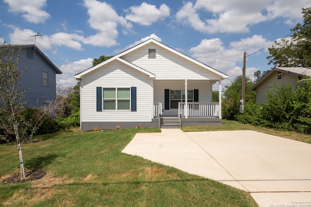 bungalow featuring a front yard and covered porch