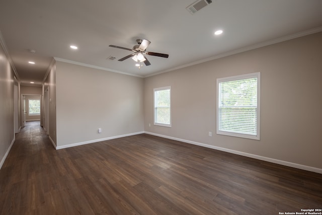 empty room featuring crown molding, dark hardwood / wood-style floors, and ceiling fan