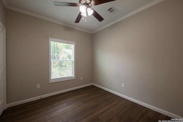 empty room with ornamental molding, ceiling fan, and dark hardwood / wood-style flooring