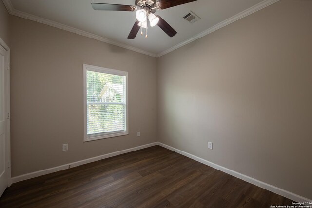 219 Gray St, San Antonio, TX 78208 - spare room featuring dark wood-style floors, baseboards, visible vents, ceiling fan, and ornamental molding