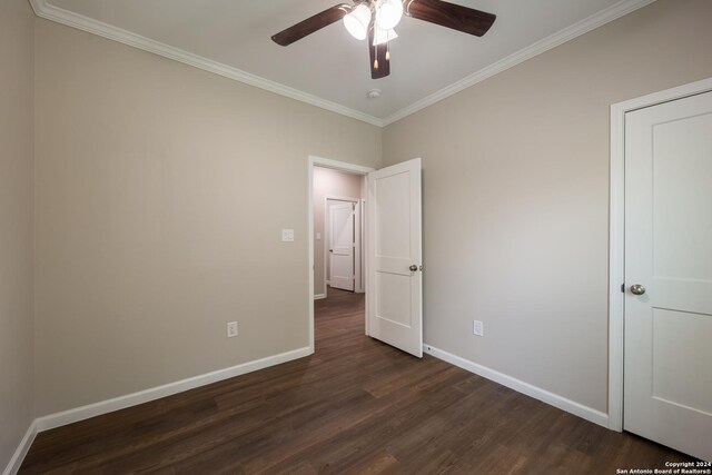 219 Gray St, San Antonio, TX 78208 - unfurnished bedroom with a ceiling fan, baseboards, dark wood-type flooring, and ornamental molding