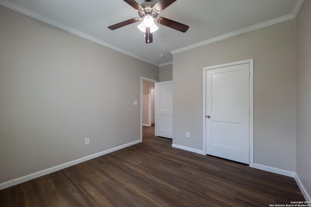 219 Gray St, San Antonio, TX 78208 - unfurnished bedroom featuring dark wood-type flooring, crown molding, baseboards, and ceiling fan
