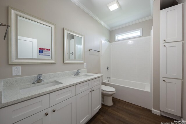 219 Gray St, San Antonio, TX 78208 - bathroom with wood finished floors, a sink, ornamental molding, and toilet