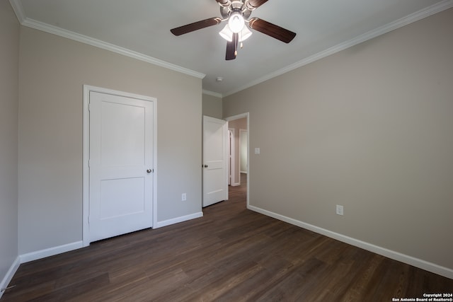 unfurnished bedroom with ceiling fan, ornamental molding, and dark wood-type flooring