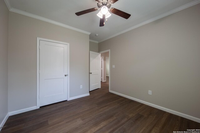 219 Gray St, San Antonio, TX 78208 - unfurnished bedroom with ceiling fan, baseboards, dark wood-style flooring, and crown molding
