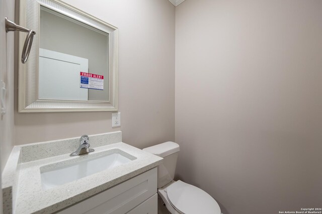 219 Gray St, San Antonio, TX 78208 - half bathroom featuring vanity and toilet