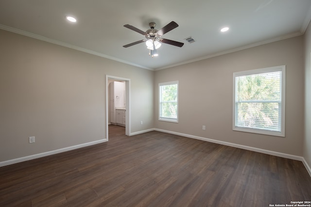 spare room featuring ceiling fan, dark wood-type flooring, and crown molding