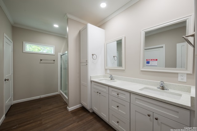 bathroom featuring crown molding, wood-type flooring, vanity, and an enclosed shower