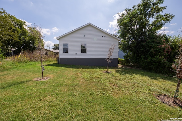 view of side of property with a lawn