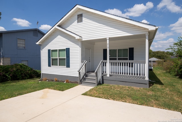 bungalow-style house with a front lawn and covered porch