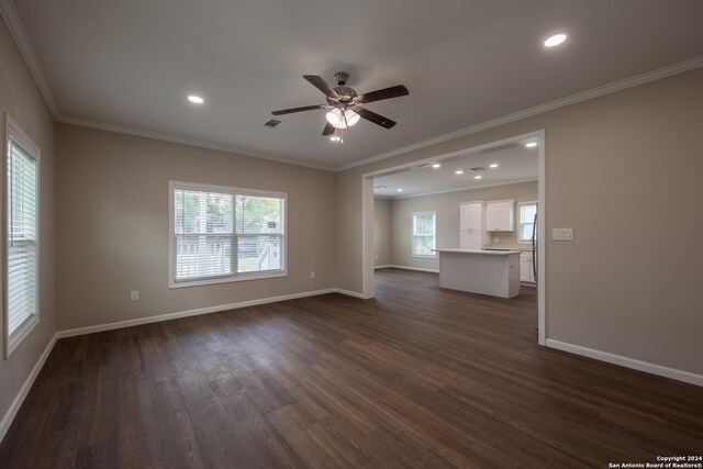219 Gray St, San Antonio, TX 78208 - unfurnished living room featuring baseboards, dark wood-type flooring, and ornamental molding