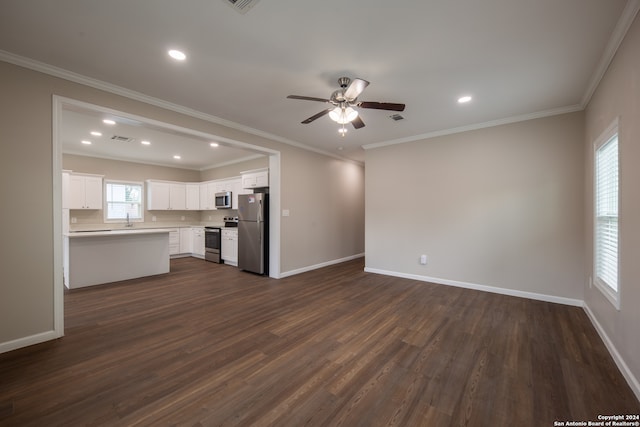 unfurnished living room with sink, ceiling fan, dark hardwood / wood-style floors, and crown molding