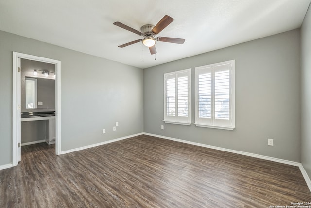 spare room with ceiling fan and dark wood-type flooring