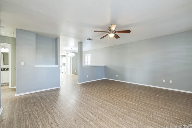 empty room with ceiling fan and hardwood / wood-style flooring