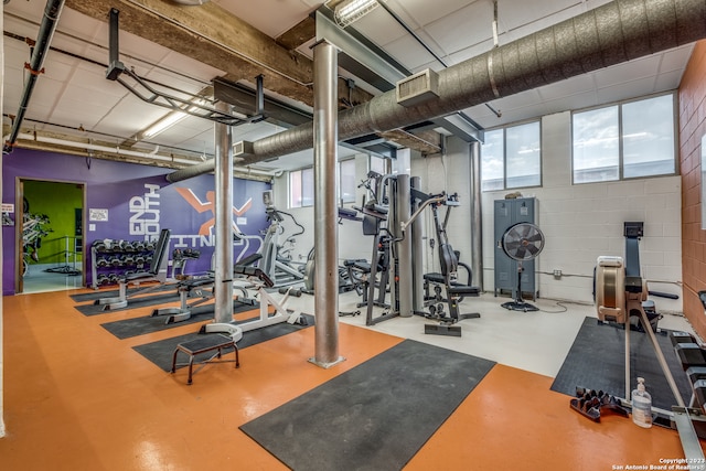 exercise room featuring concrete flooring