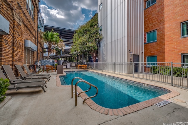 view of swimming pool featuring a patio