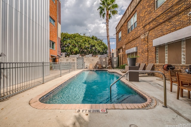 view of swimming pool featuring a patio