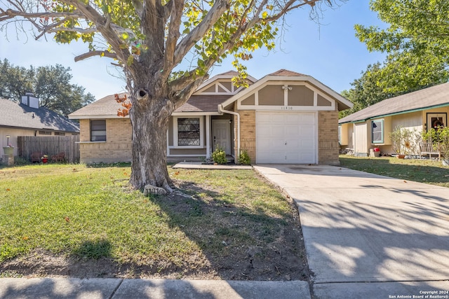 view of front of property featuring a front yard and a garage