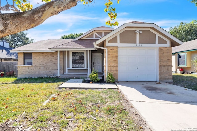 view of front of property with a front yard and a garage