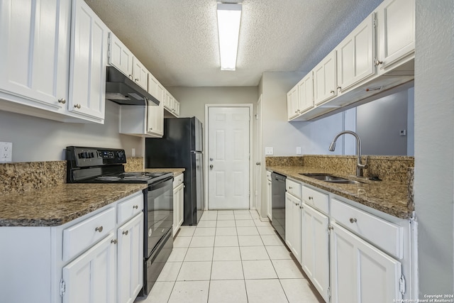 kitchen featuring dark stone countertops, black appliances, white cabinetry, and sink