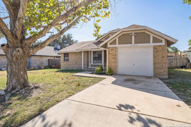 ranch-style home featuring a front yard and a garage