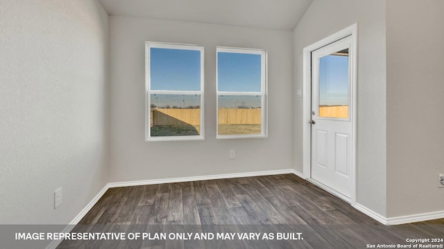 empty room with lofted ceiling, baseboards, and dark wood-style floors
