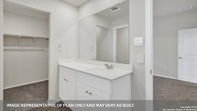 bathroom with visible vents, vanity, and baseboards