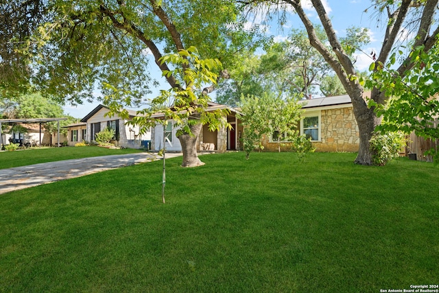 single story home featuring a carport and a front yard