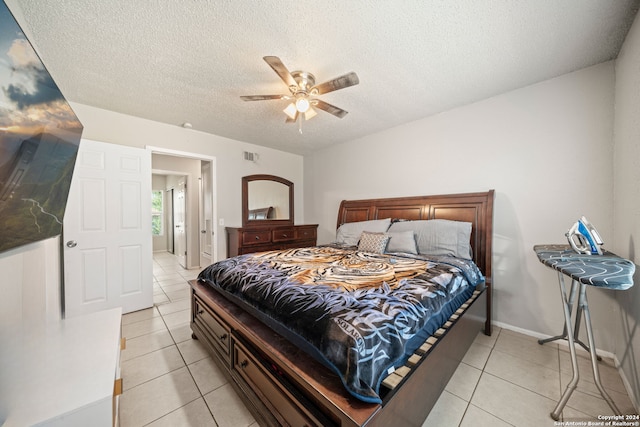 tiled bedroom featuring a textured ceiling and ceiling fan