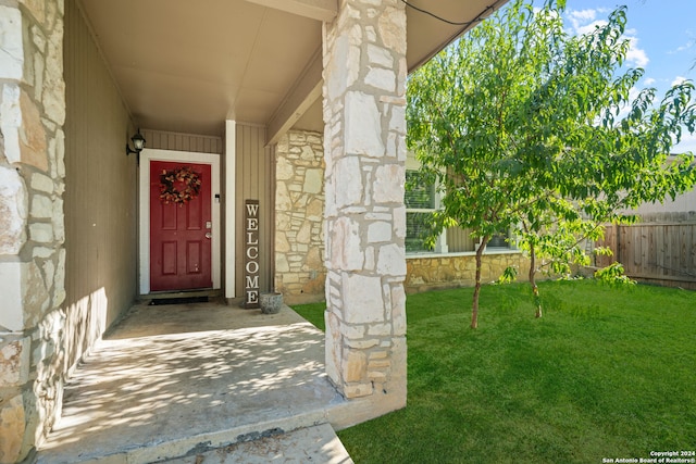 property entrance with a yard