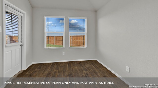 unfurnished room featuring vaulted ceiling and dark hardwood / wood-style floors