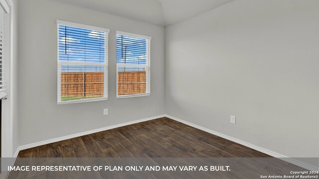 spare room featuring dark wood-type flooring