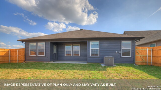 back of house with cooling unit, a lawn, and a patio area