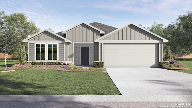 view of front of property featuring a garage and a front lawn