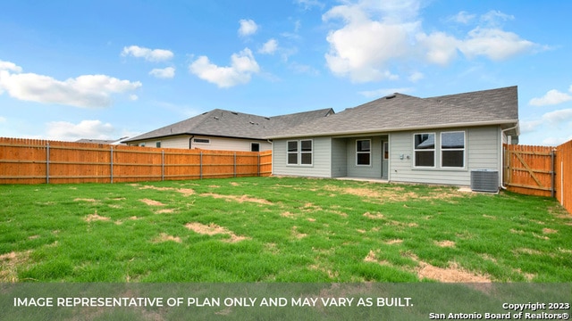 back of property with a lawn and central AC unit