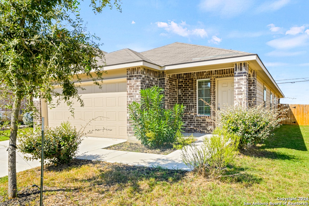 view of front of home with a front lawn and a garage