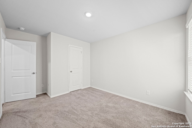 unfurnished bedroom with carpet floors and a closet