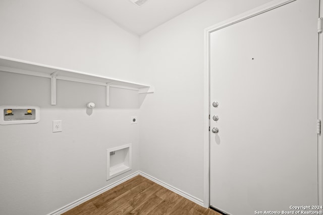 washroom featuring wood-type flooring, washer hookup, gas dryer hookup, and hookup for an electric dryer