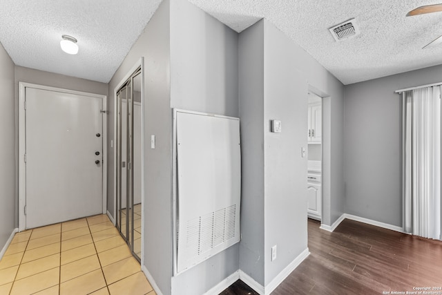 hallway featuring a textured ceiling and hardwood / wood-style flooring