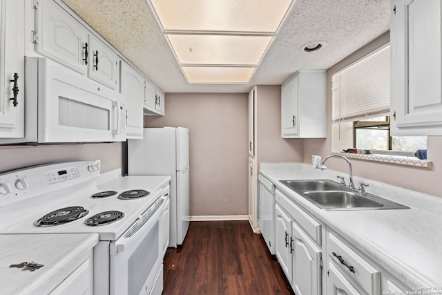 kitchen featuring white appliances, sink, dark hardwood / wood-style flooring, and white cabinets