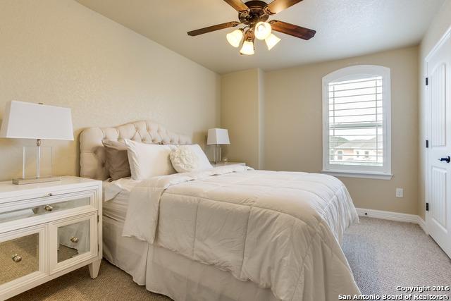 bedroom with light carpet and ceiling fan