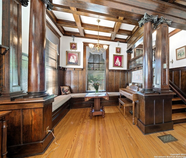 office with light wood-type flooring, beam ceiling, wood walls, and an inviting chandelier