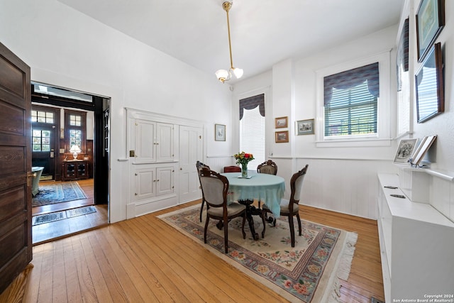 dining space featuring an inviting chandelier and light hardwood / wood-style floors