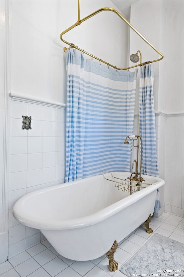 bathroom with tile patterned floors and a washtub