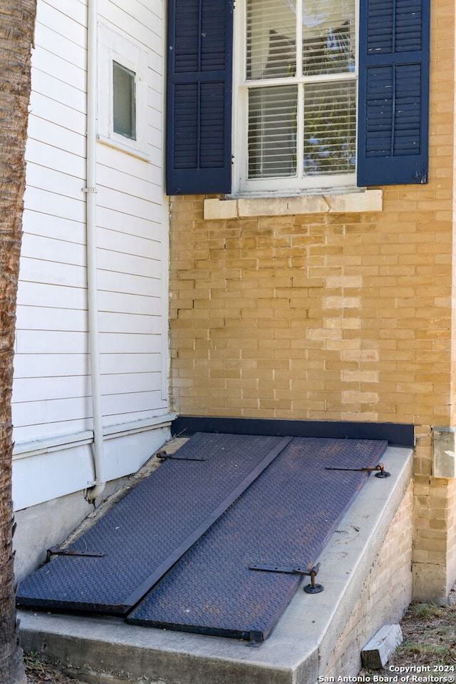 workout area featuring brick wall