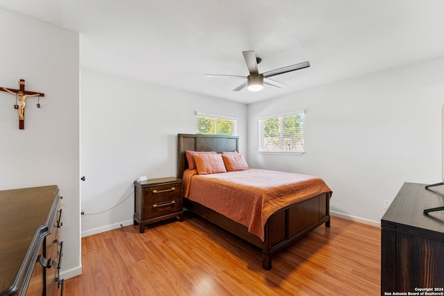 bedroom with light hardwood / wood-style floors and ceiling fan