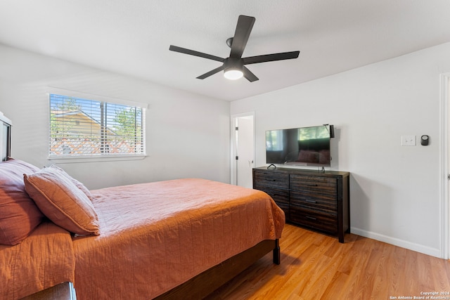 bedroom with ceiling fan and light hardwood / wood-style flooring